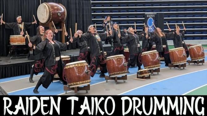 Large group of drummers performing with their traditional japanese drums