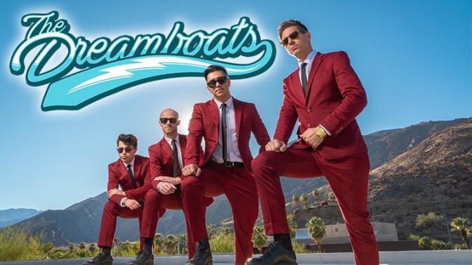 4 members of group dreamboats in burgundy suits and sunglasses