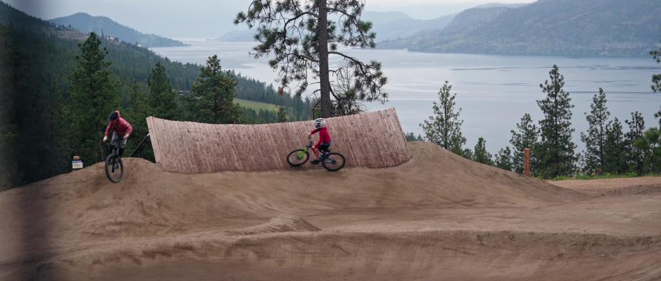 Kids riding their bikes over berms