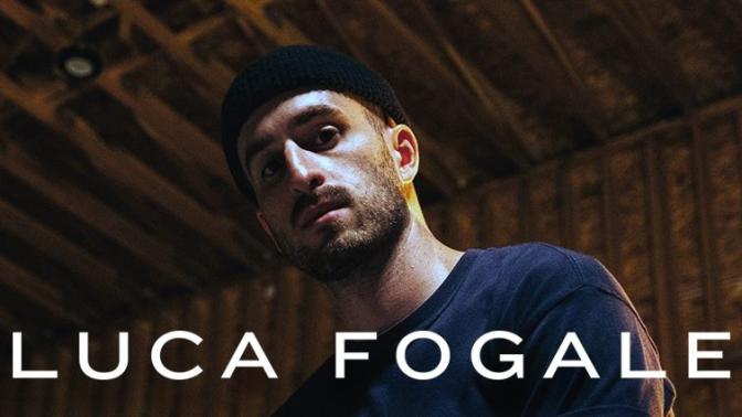 Hig contrast portrait of the Artist Luca Fogale dressed in a Navy blue shirt and Black Beanie