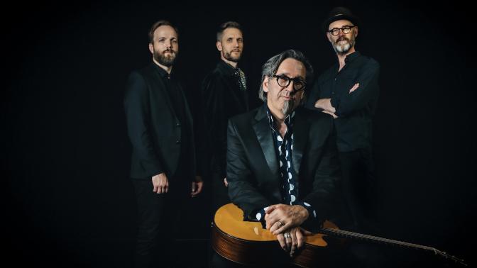 portrait of stephen fearing an his band the sentimentals set in a dark room