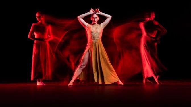 dramatic red and black shadowy image of a ballerina in three poses