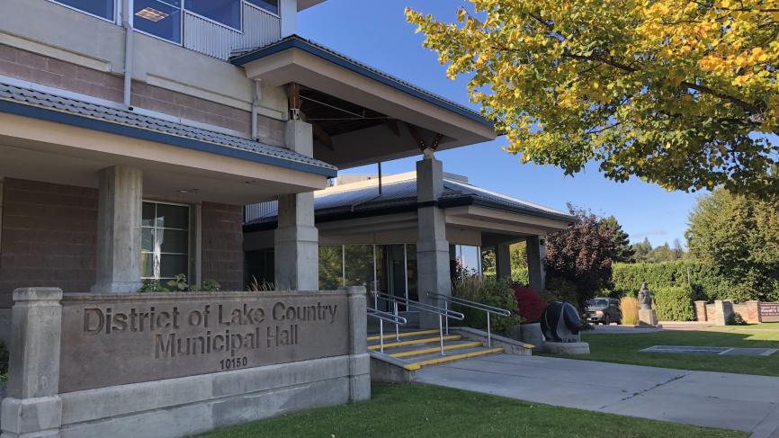 Municipal Hall with sign in the fall