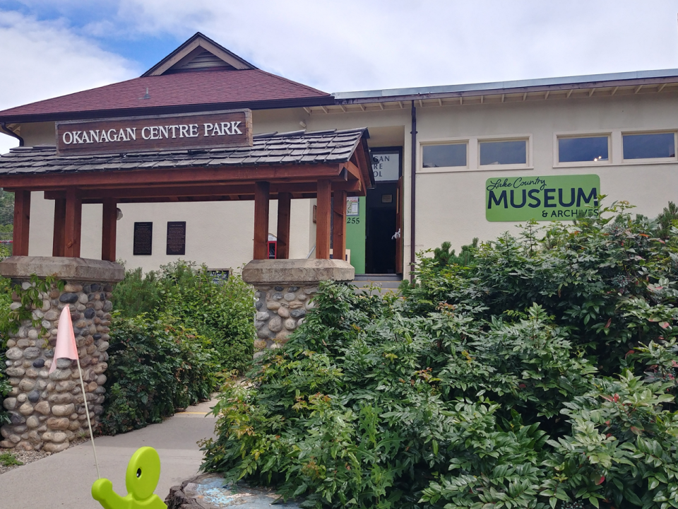 Exterior of the Lake Country Museum & Archives located in Okanagan Centre Park, surrounded by lush greenery.