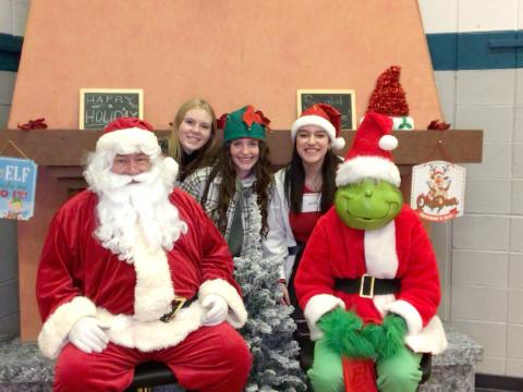 students with santa and grinch