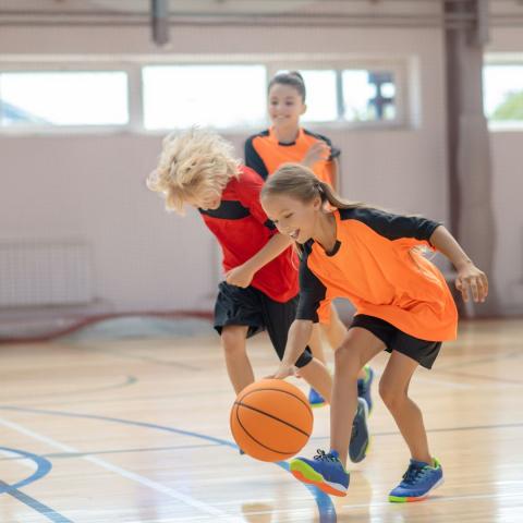 Three kids running in gym