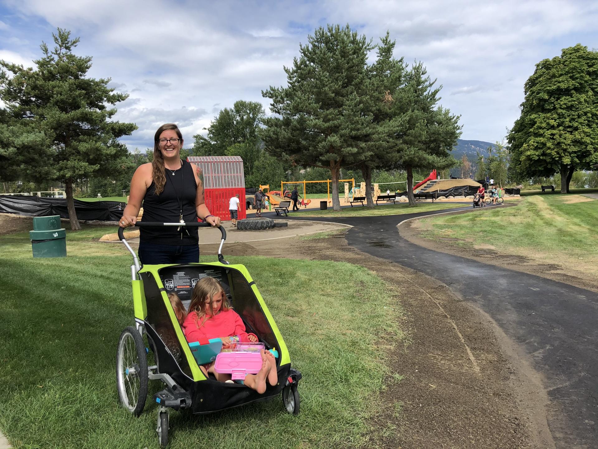 Mom with a child in stroller visit the playground at Beasley Park