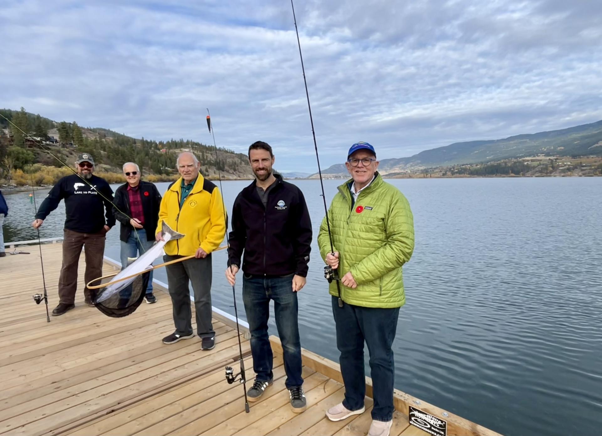 Oceola Fish and Game Club Rotary Club BC Freshwater Fisheries Society and Lake Country Mayor stand on accessible fishing dock