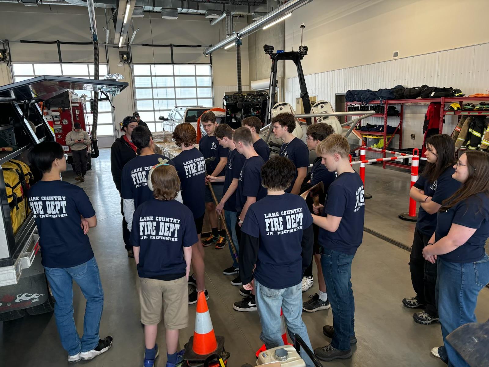 junior firefighters learn explore a fire truck